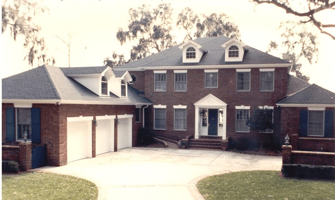 A large brick house with two garage doors.