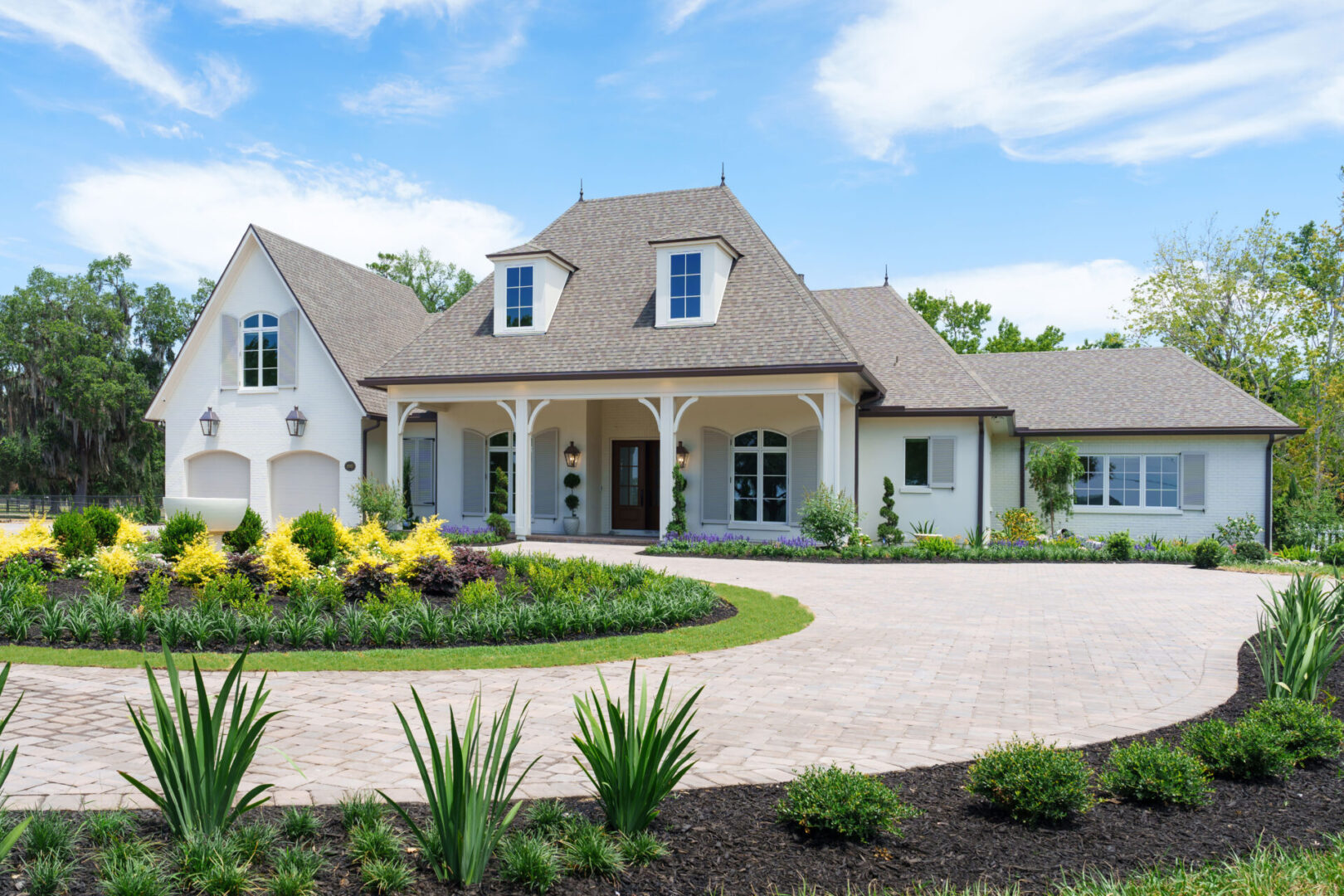 A large white house with a circular driveway.